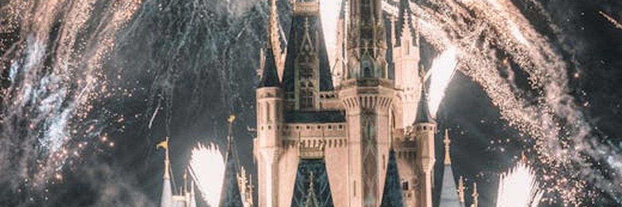 Enchanting night view of a famous castle illuminated by spectacular fireworks, capturing a magical ambiance.